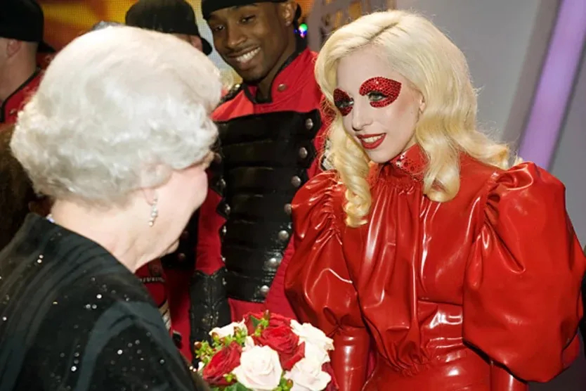 Lady Gaga wearing a latex outfit meeting the Queen of England (2009)